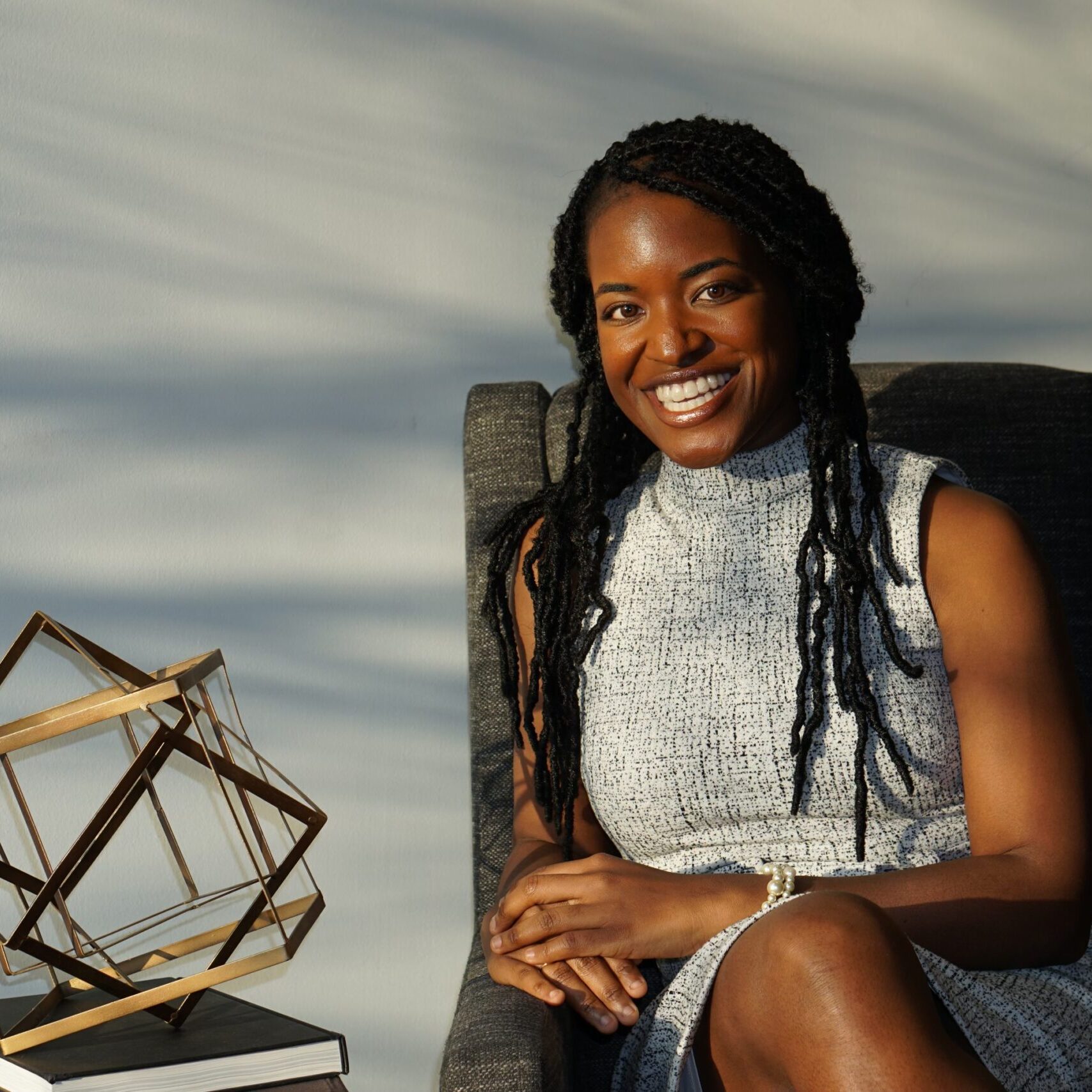 Graduate level clinician Brittney Walker sitting in a chair.