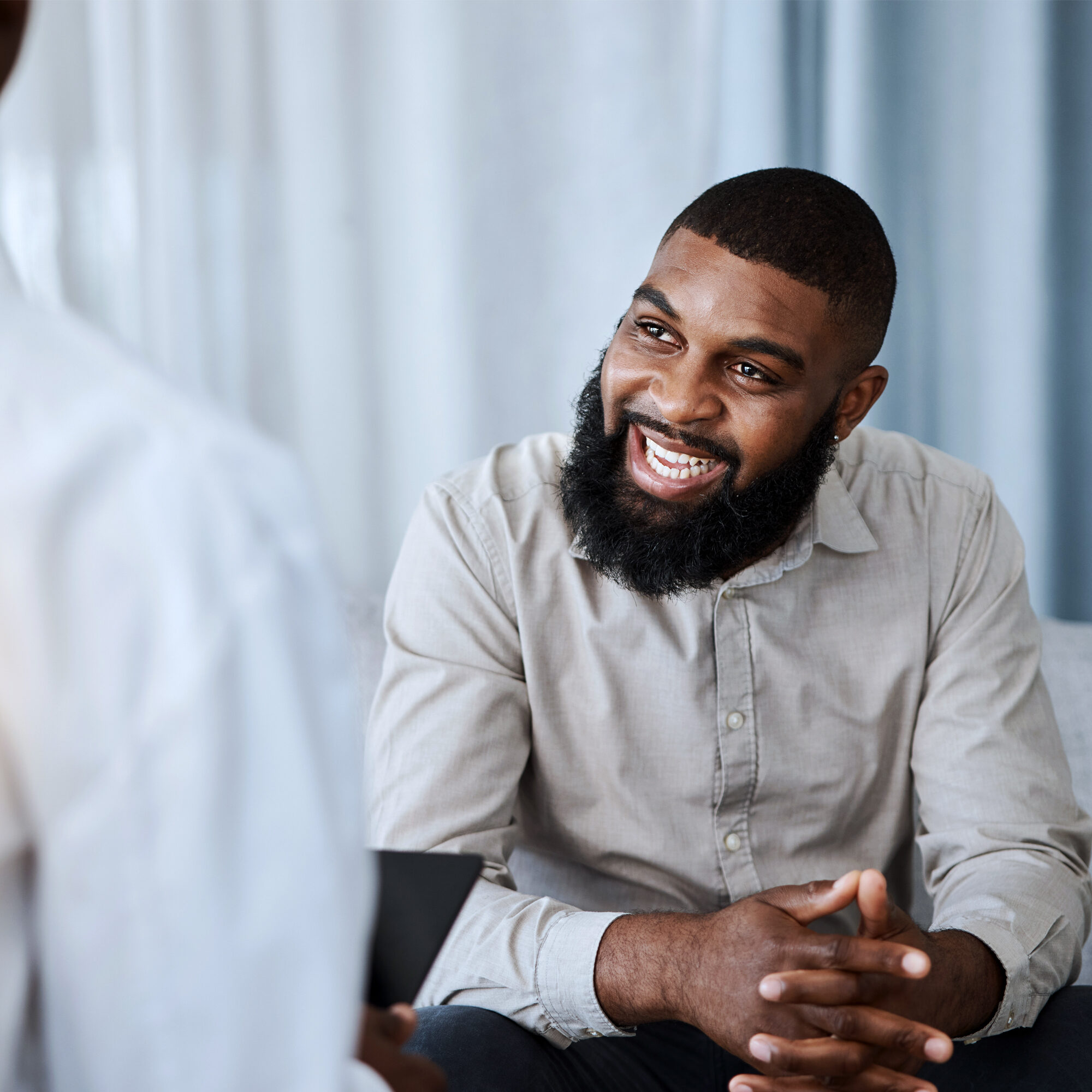 A black male patient at therapy smiling